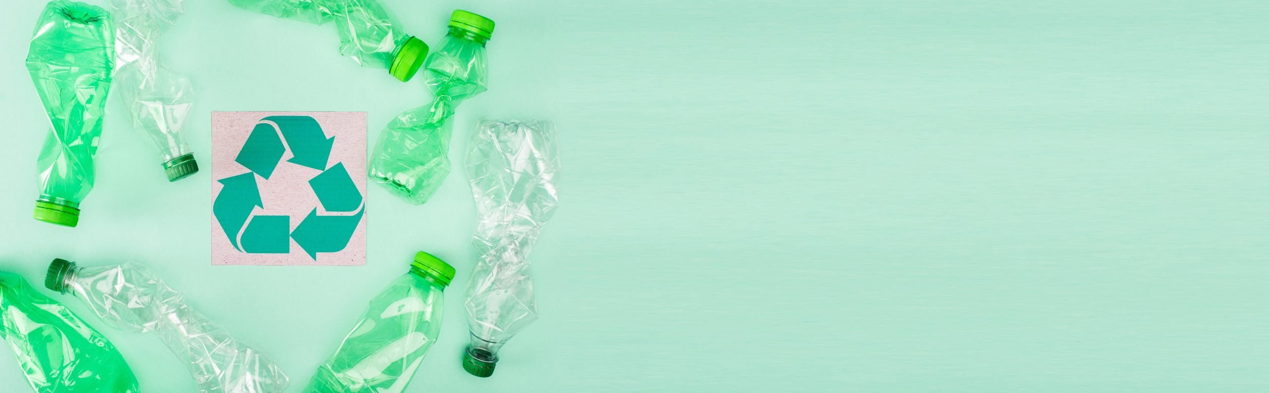 Panoramic Concept Of Crumpled Plastic Bottles Near Card With Recycle Symbol On Green Background, Ecology Concept
